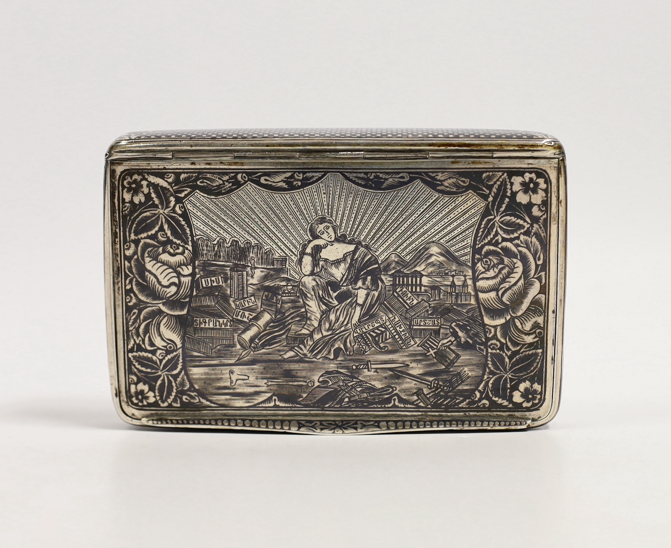 A 19th century Russian? white metal and niello rectangular snuff box, decorated with a pensive figure in a landscape with script, unmarked, 97mm, 119 grams.